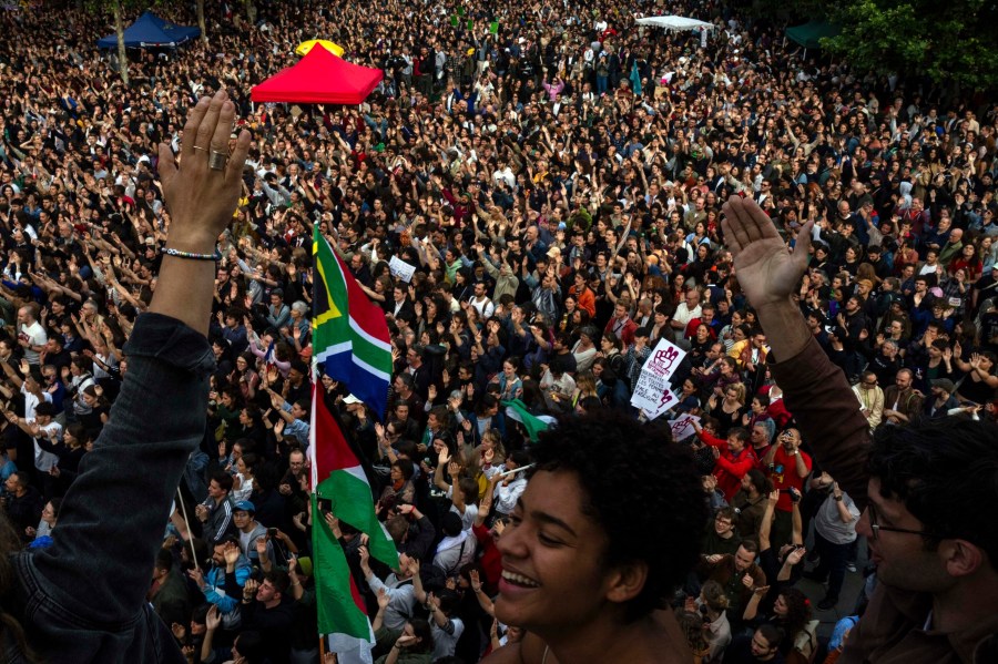 People gather at Republique plaza in a protest against the far-right, Wednesday, July 3, 2024, in Paris. (AP Photo/Louise Delmotte)