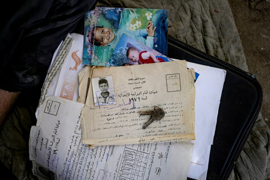 Documents belong to Palestinian Omar Fayad, who was displaced by the Israeli bombardment of the Gaza Strip, are seen at a makeshift tent camp in Deir al-Balah, central Gaza Strip, Monday, July 8, 2024. Over nine months of war between Israel and Hamas, Palestinian families in Gaza have been uprooted repeatedly, driven back and forth across the territory to escape the fighting. Each time has meant a wrenching move to a new location and a series of crowded, temporary shelters. (AP Photo/Abdel Kareem Hana)