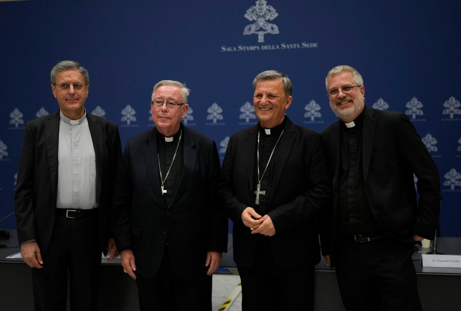 From left, Monsignor Riccardo Batocchio, Cardinal Jean-Claude Hollerich, Cardinal Mario Grech and father Giacomo Costa pose for a photo after a press conference to present the "Instrumentum Laboris", a preparatory document in view of the 16th Ordinary General Assembly of the Synod of Bishops, at the Vatican,Tuesday, July 9, 2024. (AP Photo/Alessandra Tarantino)