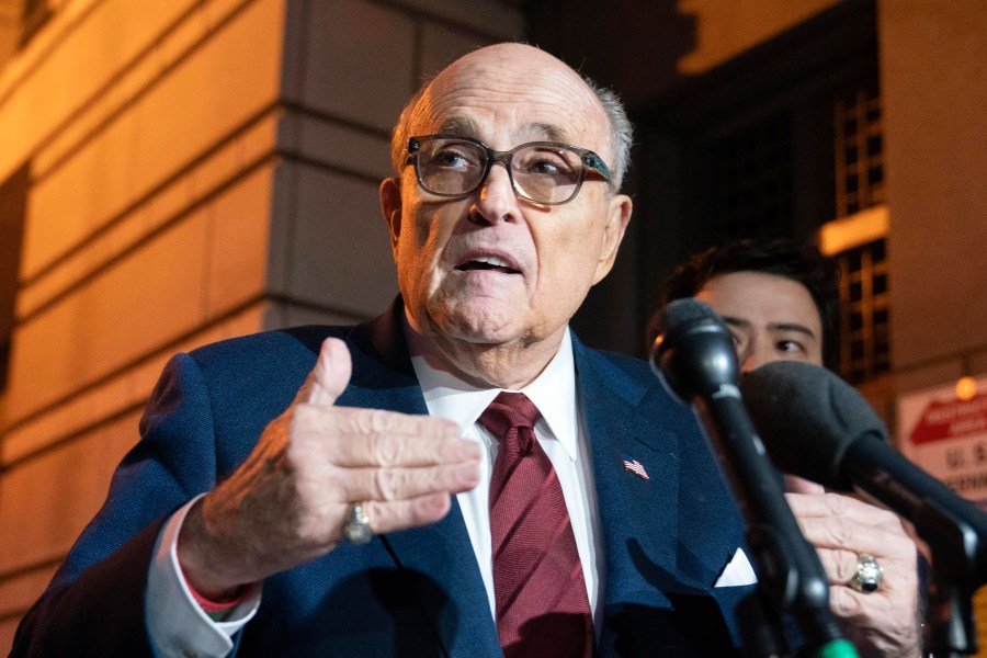 FILE - Former New York Mayor Rudy Giuliani talks to reporters as he leaves the federal courthouse in Washington, Dec. 11, 2023. A judge said Wednesday, July 10, 2024, he was leaning toward throwing out Giuliani's bankruptcy case after lawyers and his biggest creditors agreed this was the best way forward. (AP Photo/Jose Luis Magana, File)