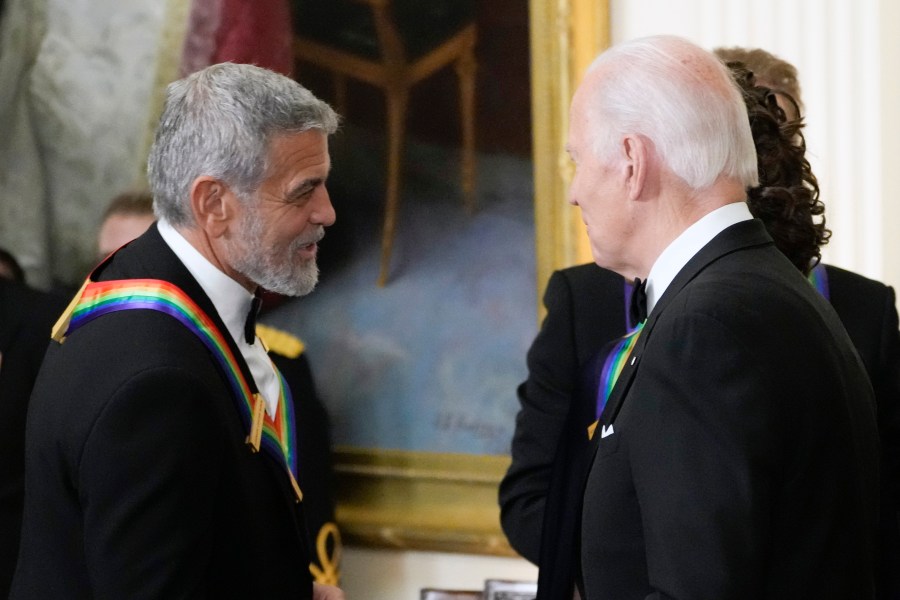 FILE - President Joe Biden shakes hands with actor, director and producer George Clooney during the Kennedy Center honorees reception at the White House in Washington, Dec. 4, 2022. Movie star and lifelong Democrat George Clooney is adding his voice to calls for Joe Biden to leave the presidential race. Clooney says in a New York Times opinion piece Wednesday that he loves Biden, but the party would lose the presidential race as well as any control in Congress with him as the nominee. (AP Photo/Manuel Balce Ceneta)