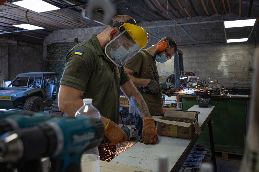 Engineers of design and production bureau "UkrPrototyp" work on new parts for a ground drone, in northern Ukraine, Thursday, June 27, 2024. Facing manpower shortages and uneven international assistance, Ukraine is struggling to halt Russia’s incremental but pounding advance in the east and is counting heavily on innovation at home. (AP Photo/Anton Shtuka)