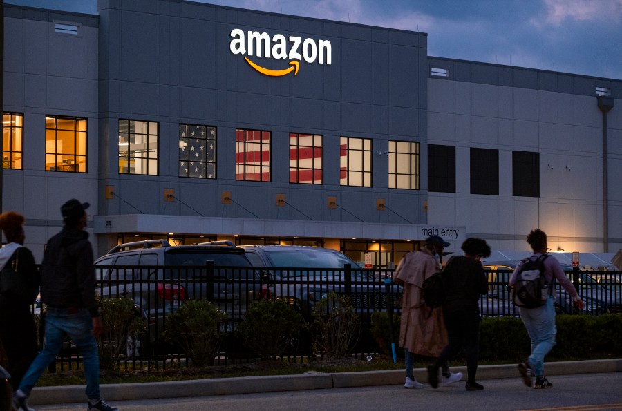 FILE - People arrive for work at the Amazon distribution center in the Staten Island borough of New York, on Oct. 25, 2021. A report released by U.S. Senator Bernie Sanders said Amazon's popular Prime Day sales event has been "a major cause of injuries" for warehouse workers who organize packages at its facilities across the country. (AP Photo/Craig Ruttle, File)