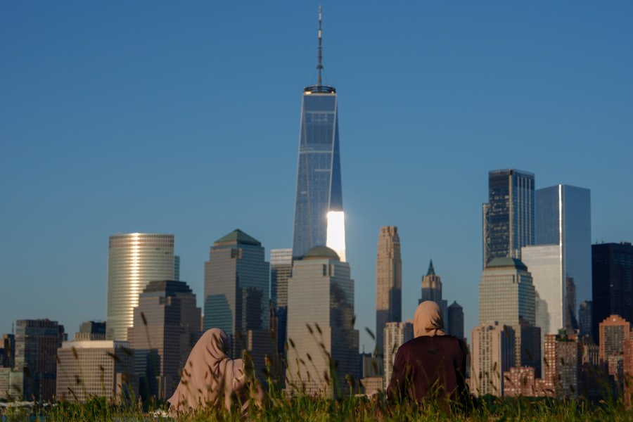 FILE - People look out at the New York City skyline at sunset, Sunday, June 16, 2024, in Jersey City, N.J. A meteor streaked across the New York City skyline before disintegrating over nearby New Jersey, according to NASA. William Cooke, the head of the space agency's Meteoroid Environments Office, said the fireball was first sighted at an altitude of 51 miles (82 kilometers) above Manhattan at around 11:17 a.m. Tuesday, Juky 14, 2024. (AP Photo/Julia Nikhinson, File)