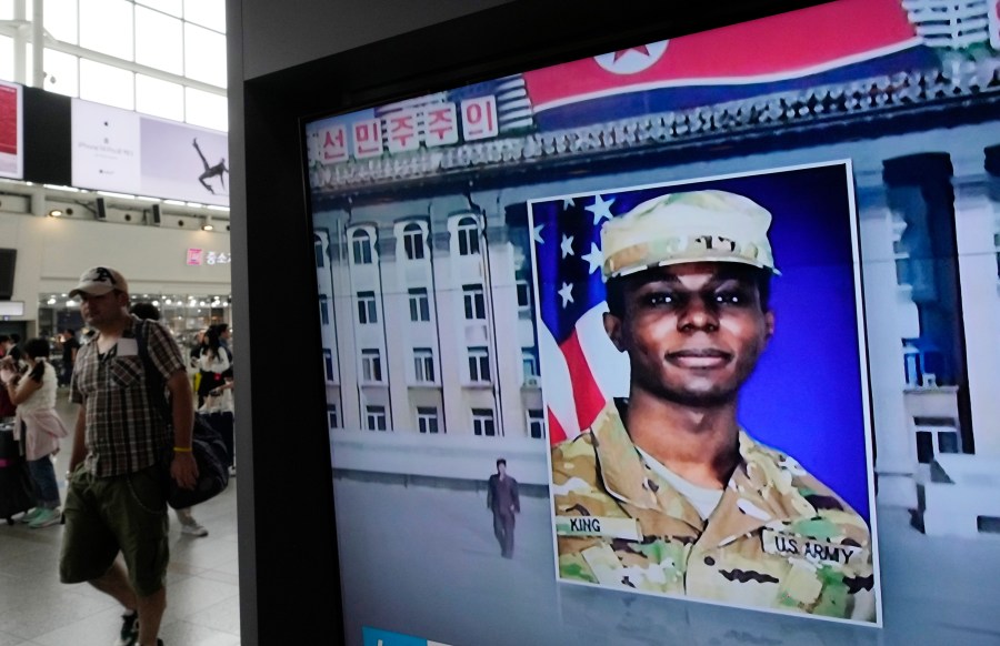 FILE - A TV screen shows a file image of American soldier Travis King during a news program at the Seoul Railway Station in Seoul, South Korea on Aug. 16, 2023. A lawyer for Army Pvt. King, who fled to North Korea and was later charged with desertion and possessing sexual images of a child, says he's in negotiations with military prosecutors to resolve the case against his client. King had been scheduled for a preliminary hearing Tuesday in Fort Bliss, Texas. (AP Photo/Ahn Young-joon, File)