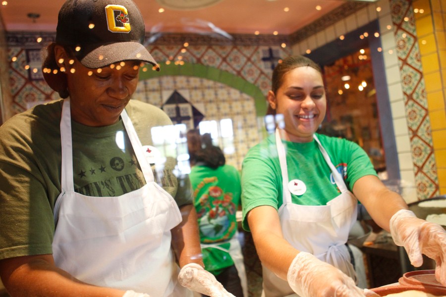 FILE - Latrice Walker and Christina Rivera make fresh tortillas on opening day at Chuy's in Jacksonville, N.C., May 13, 2014. On Wednesday, July 17, 2024, Darden Restaurants announced it's buying Chuy's restaurant chain. (AP Photo/The Daily News, Maria Sestito, File)