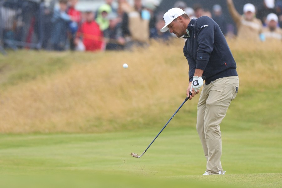 Bryson DeChambeau of the United States chips onto the 18th green during his opening round of the British Open Golf Championships at Royal Troon golf club in Troon, Scotland, Thursday, July 18, 2024. (AP Photo/Scott Heppell)