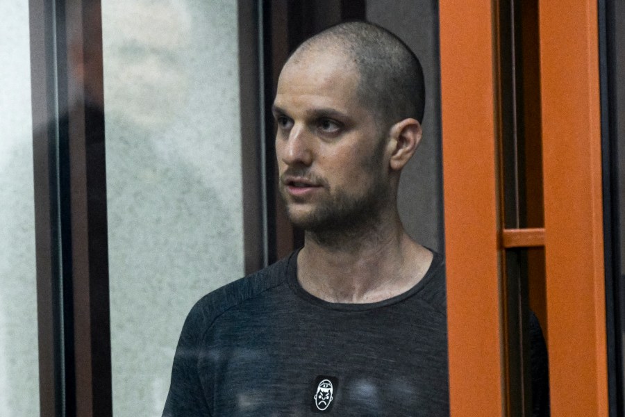 Wall Street Journal reporter Evan Gershkovich stands listening to the verdict in a glass cage of a courtroom inside the building of "Palace of justice," in Yekaterinburg, Russia, on Friday, July 19, 2024. A Russian court convicted Gershkovich on espionage charges that his employer and the U.S. have rejected as fabricated. He was sentenced to 16 years in prison after a secretive and rapid trial in the country's highly politicized legal system. (AP Photo)