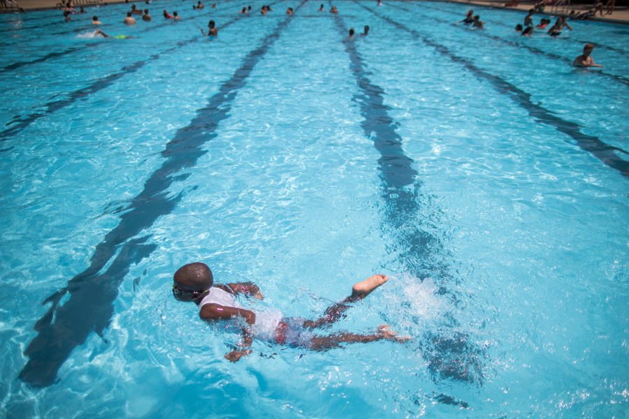 FILE - Children cool off at the Hamilton Fish pool, July 18, 2017, in the Lower East Side neighborhood of Manhattan. In most cases, there’s no need to wait at least 30 minutes after eating to go for a swim, doctors say. (AP Photo/Mary Altaffer, File)