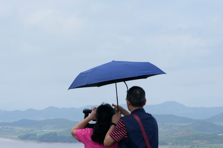 A couple watches the North Korea side from the Unification Observation Post in Paju, South Korea, near the border with North Korea, Sunday, July 21, 2024. (AP Photo/Ahn Young-joon)