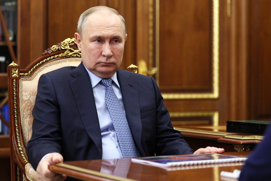 Russian President Vladimir Putin listens to RusHydro Director General Viktor Khmarin during their meeting at the Kremlin in Moscow, Russia, Monday, July 22, 2024. (Vyacheslav Prokofyev, Sputnik, Kremlin Pool Photo via AP)