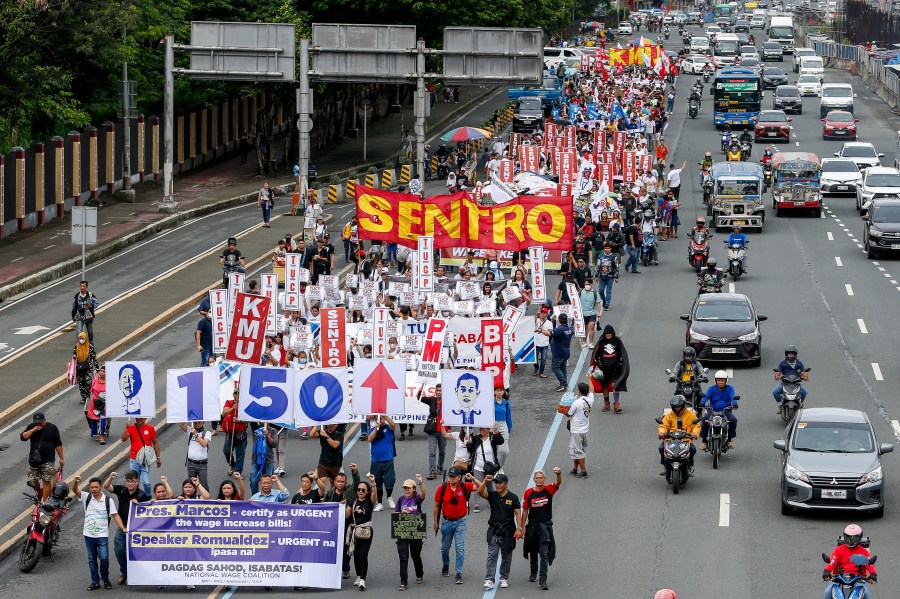 Demonstrators march along the main road heading to the House of Representatives ahead of the third State of the Nation Address of Philippine President Ferdinand Marcos Jr. in Quezon City, Philippines, Monday, July 22, 2024. (AP Photo/Mark Cristino)