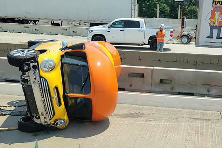 In this photo provided by Chicago Critter, one of Oscar Mayer’s hot dog-shaped Wienermobiles is flipped onto its side after crashing along Interstate 294, a suburban Chicago highway, Monday, July 22, 2024, in Oak Brook, Ill. (Chicago Critter via AP)