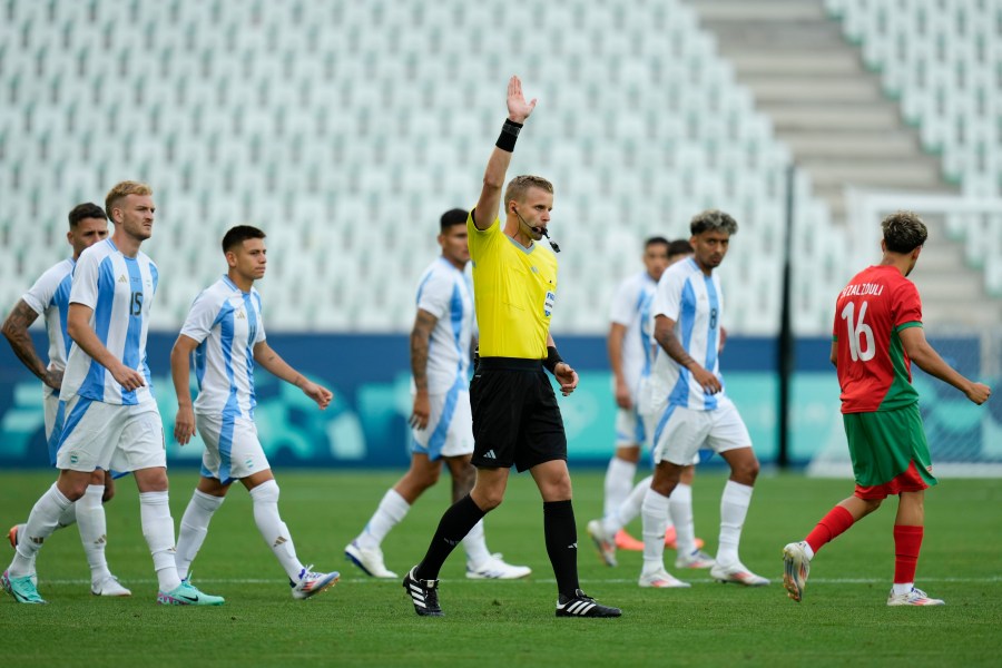 Referee Glenn Nyberg disallows a goal scored by Argentina's Cristian Medina during the Men's Group B soccer match between Argentina and Morocco at Geoffroy-Guichard stadium during the 2024 Summer Olympics, Wednesday, July 24, 2024, in Saint-Etienne, France. (AP Photo/Silvia Izquierdo)