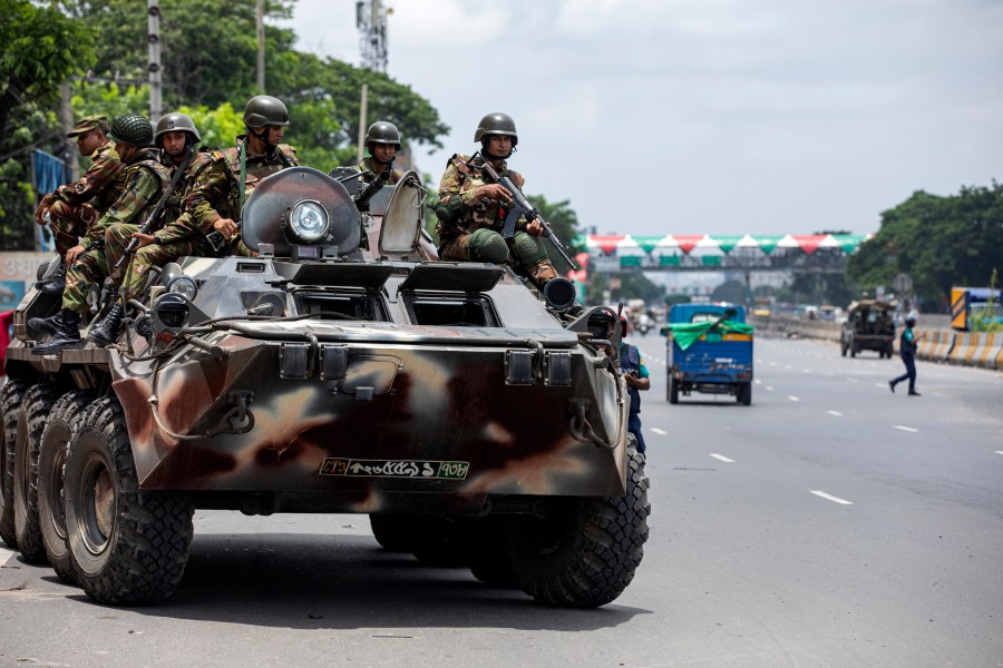 Bangladeshi army patrols in an armored vehicle the Dhaka-Chittagong highway on the fourth day of curfew imposed by the government amidst the countrywide deadly clashes, in Dhaka, Bangladesh, Tuesday, July 23, 2024. Internet and mobile data services are still down despite apparent calm in Bangladesh following a verdict that scaled back a controversial quota system for government jobs after weeks of relentless protests that turned deadly. (AP Photo/Rajib Dhar)