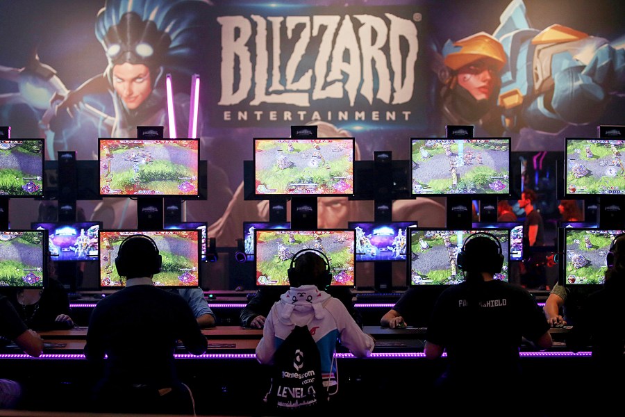 FILE - Gamers test out computer games at the Gamescom in Cologne, Germany, on Aug. 22, 2017. More than 500 workers behind the popular video game franchisee “World of Warcraft” are joining the Communications Workers of America, the union announced Wednesday, July 24, 2024. Microsoft subsidiary Blizzard Entertainment, World of Warcraft's publisher, has recognized the union. (Oliver Berg/DPA via AP, File)