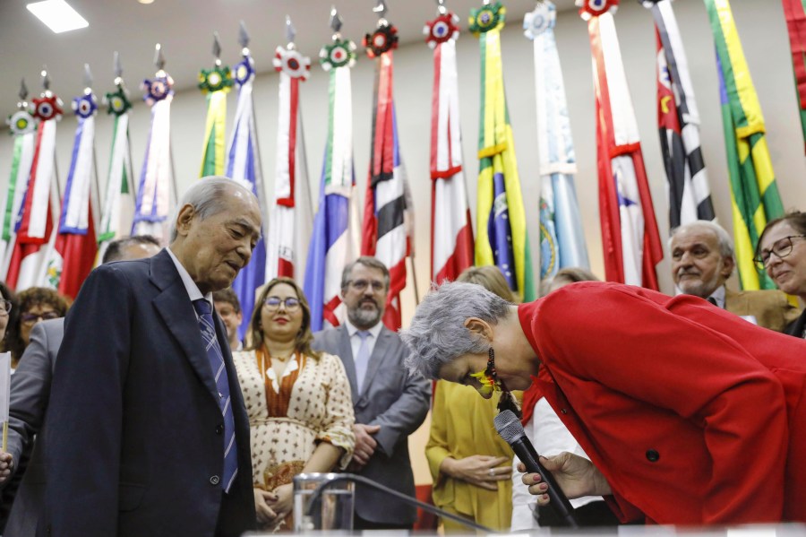 Eneá de Stutz e Almeida, right, president of the Amnesty Commission lowers her head as she apologizes in Brasilia, Brazil Thursday, July 25, 2024. The Brazilian government on Thursday apologized for human rights violations in the persecution and internment of Japanese immigrants in the years after World War II. (Kyodo News via AP)