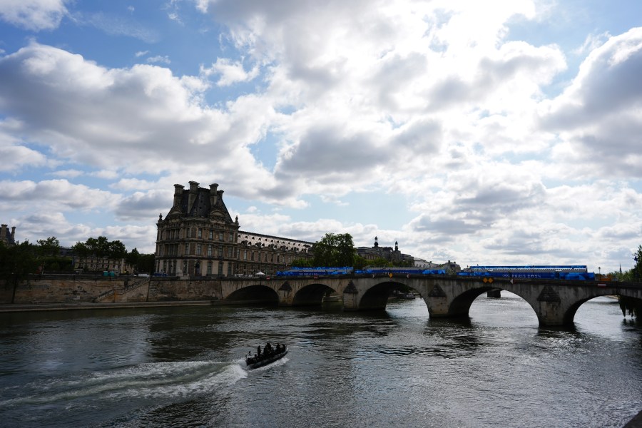 A bomb squad boat navigates the Seine River as officials prepare for Friday's opening ceremony, ahead of the 2024 Summer Olympics, Monday, July 22, 2024, in Paris, France. (AP Photo/Rebecca Blackwell)