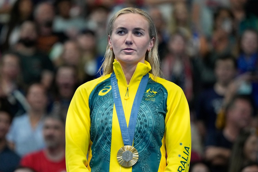 Ariarne Titmus, of Australia, stands on the podium after winning the women's 400-meter freestyle final at the 2024 Summer Olympics, Saturday, July 27, 2024, in Nanterre, France. (AP Photo/Matthias Schrader)