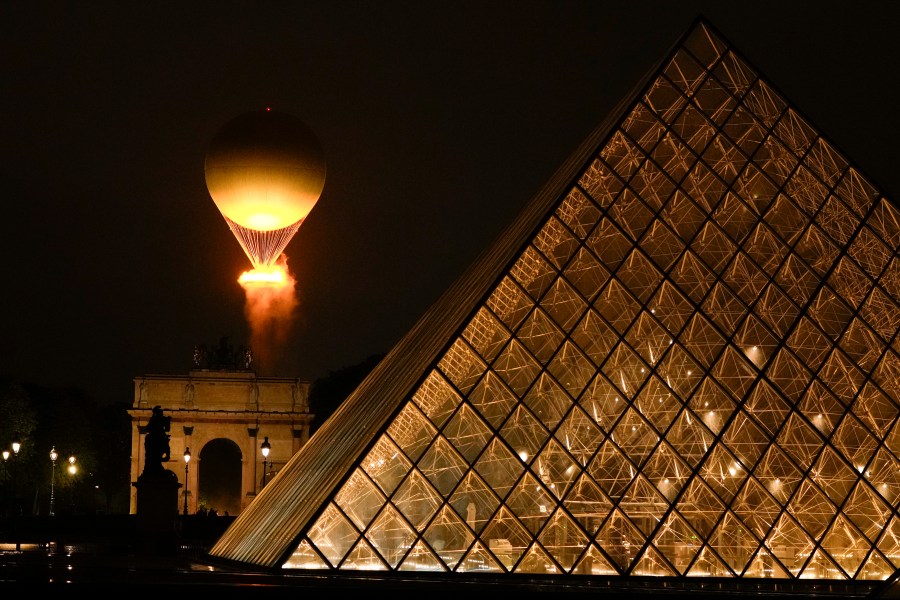 The Olympic Flame rises on a balloon after being lit in Paris, France, during the opening ceremony of the 2024 Summer Olympics, Friday, July 26, 2024. (AP Photo/Francisco Seco)