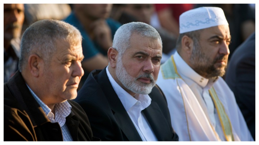 Hamas top leader Ismail Haniyeh, center, attends the Eid al-Fitr prayers marking the end of the holy fasting month of Ramadan, in Eastern Gaza City, Friday, June 15, 2018. (AP Photo/Khalil Hamra)