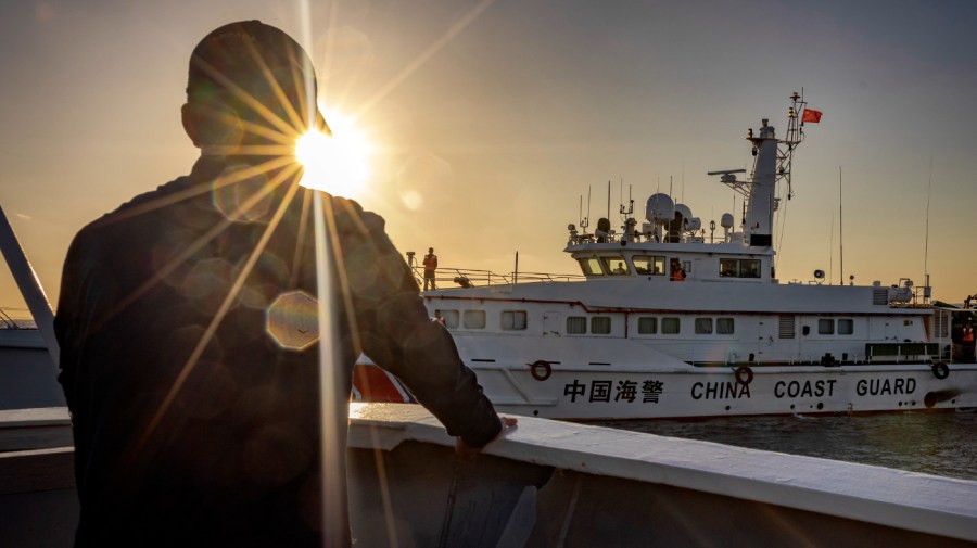 Philippine Coast Guard personnel aboard BRP Sindangan looks on as a Chinese Coast Guard ship sails nearby, during resupply mission to troops stationed at Second Thomas Shoal, on March 05, 2024 in the South China Sea. Philippine and Chinese vessels collided in the high seas, leaving four Filipinos with minor injuries after a supply vessel's windshield was shattered by water cannons, the Philippines said. The incidents happened as the Philippines was conducting a routine resupply mission to troops stationed aboard BRP Sierra Madre, a grounded Navy ship that serves as the country's outpost in Second Thomas Shoal (locally called Ayungin Shoal). (Photo by Ezra Acayan/Getty Images)