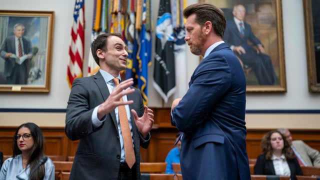 Michael Kratsios, left, managing director for Scale AI and former President Donald Trump's top technology advisor, speaks with Klon Kitchen, right, a senior fellow at the American Enterprise Institute, before Kitchen testifies to the House Armed Services' Cyber, Information Technologies, and Innovation Subcommittee on adopting and deploying artificial intelligence effectively in the modern battlefield, at the Capitol in Washington, Tuesday, July 18, 2023. (AP Photo/J. Scott Applewhite)