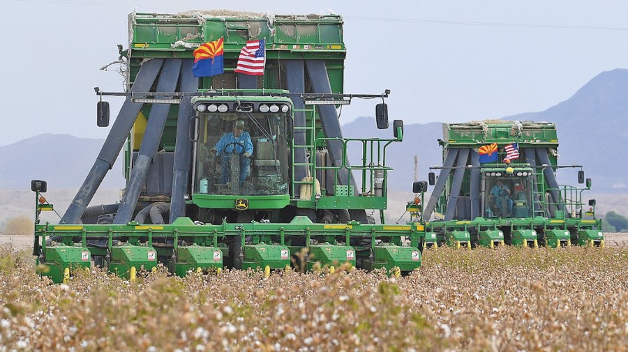 FILE - Two John Deere on board module cotton strippers, owned and operated by DVB Harvesting, work their way through a field of cotton on Aug. 21, 2020, in Winterhaven, Ariz. John Deere says it will no longer sponsor "social or cultural awareness" events as the agricultural machinery manufacturer becomes one of the latest companies to distance itself from diversity and inclusion measures.