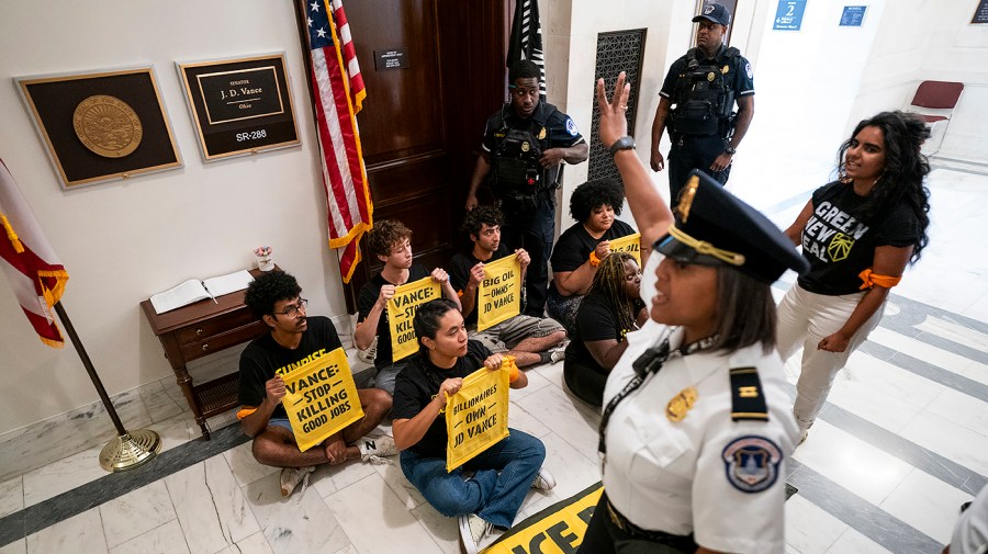 U.S. Capitol Police give a third warning to for members of Sunrise Movement to move from outside the office of Sen. JD Vance (R-Ohio) in the Russell Senate Office Building