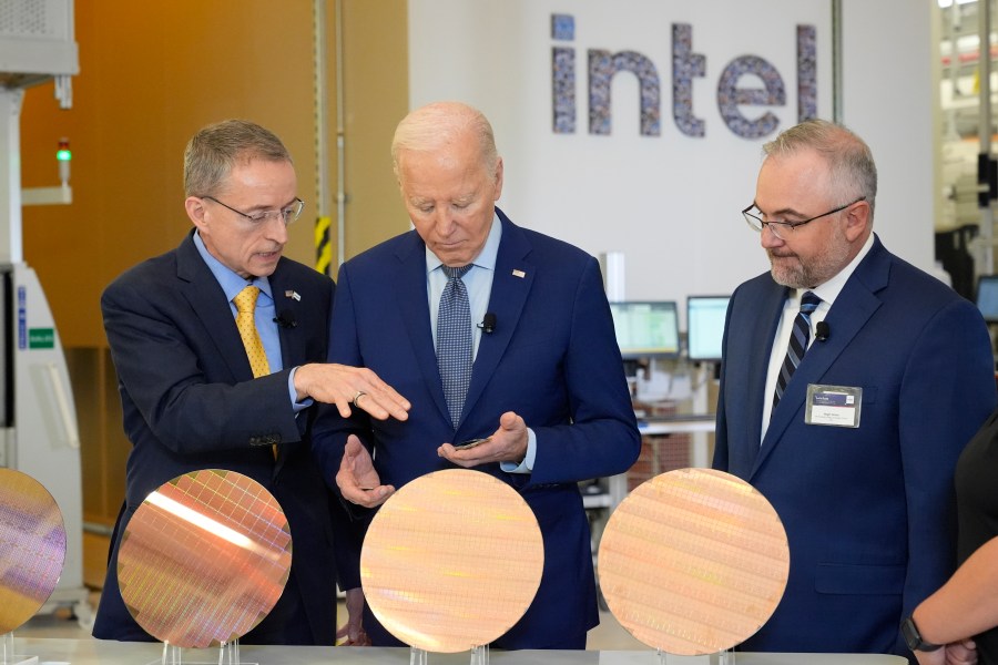 FILE - President Joe Biden listens to Intel CEO Pat Gelsinger, left, as Intel factory manager Hugh Green watches during a tour of the Intel Ocotillo Campus, in Chandler, Ariz., on March 20, 2024. Intel reports earnings on Thursday, Aug. 1, 2024. (AP Photo/Jacquelyn Martin, File)