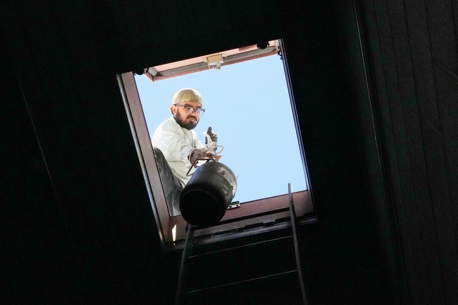 Total Refrigeration service tech Michael Villa works on an air conditioning unit as temperatures are expected to hit 117-degrees Wednesday, July 19, 2023, in Phoenix. Most of the Maricopa County's 645 heat-related deaths last year were outdoors, but 156 people died in their homes. (AP Photo/Ross D. Franklin)