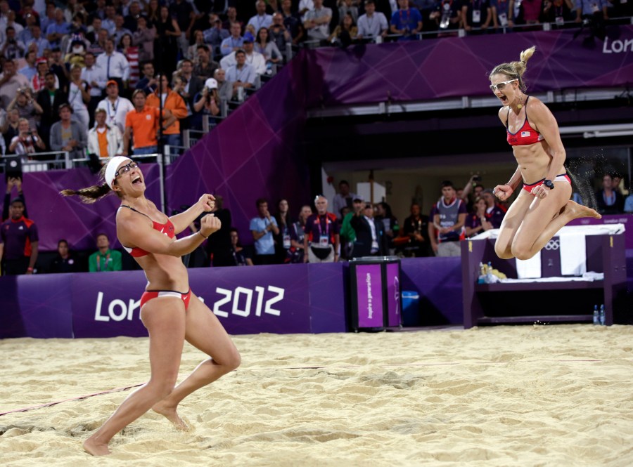 FILE _ Miss May Treanor, left, and Kerri Walsh Jennings celebrate a win over April Ross and Jennifer Kessy during the women's Gold Medal beach volleyball match between two United States teams at the 2012 Summer Olympics, Wednesday, Aug. 8, 2012, in London. (AP Photo/Dave Martin, File)