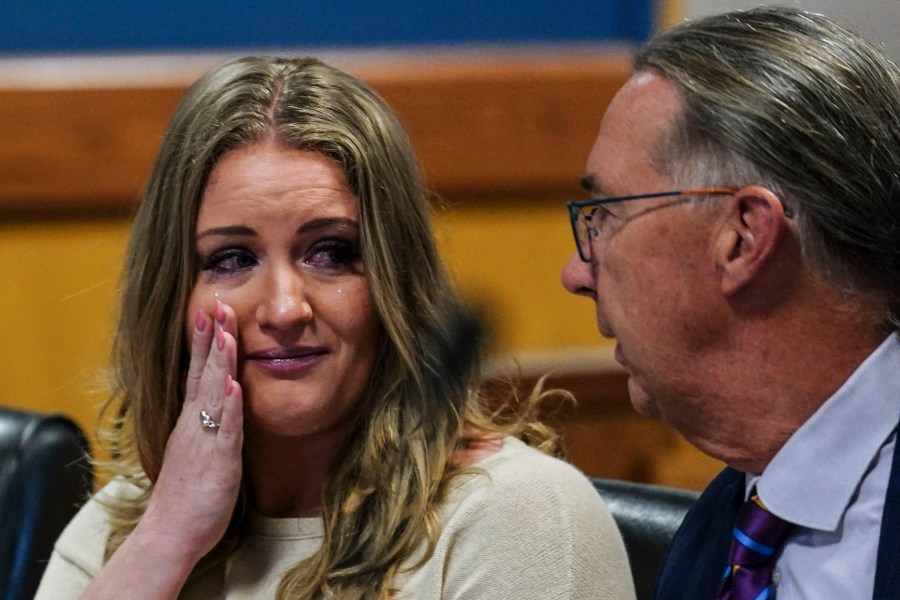 FILE - Jenna Ellis speaks with her attorney Franklin Hogue after Ellis plead guilty to a felony count of aiding and abetting false statements and writings, Oct. 24, 2023, inside Fulton Superior Court Judge Scott McAfee's Fulton County, Ga., courtroom in Atlanta. (AP Photo/John Bazemore, Pool, File)