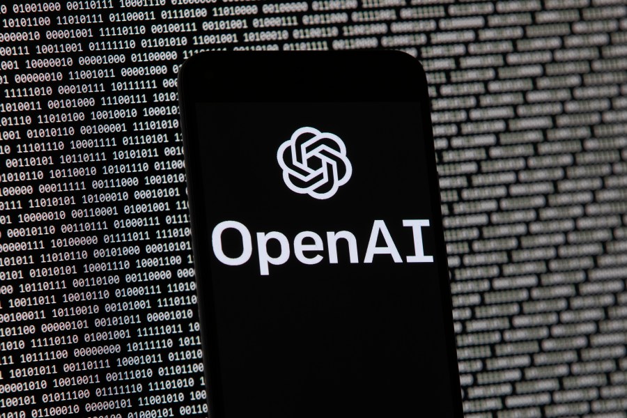 FILE - The OpenAI logo appears on a mobile phone in front of a computer screen with random binary data, March 9, 2023, in Boston. San Francisco-based OpenAI said Thursday, July 25, 2024, it is releasing a preview of the SearchGPT to a small group of users and publishers for feedback. (AP Photo/Michael Dwyer, File)