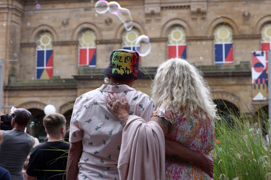 Members of the public take part in a vigil to remember the victims of the stabbing attack last Monday in Southport, England, Monday, Aug. 5, 2024. Violence and unrest erupted in cities and towns across Britain, ostensibly in protest of last week's stabbing. (AP Photo/Darren Staples)