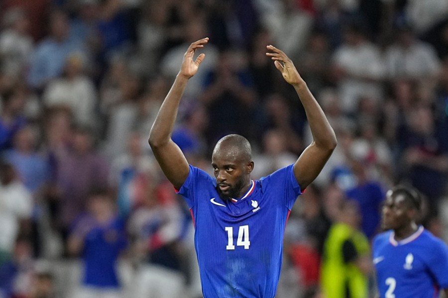 France's Jean-Philippe Mateta celebrates after scoring his side's first goal during the men's semifinal soccer match between France and Egypt, at Lyon Stadium, during the 2024 Summer Olympics, Monday, Aug. 5, 2024, in Decines, France. (AP Photo/Laurent Cipriani)