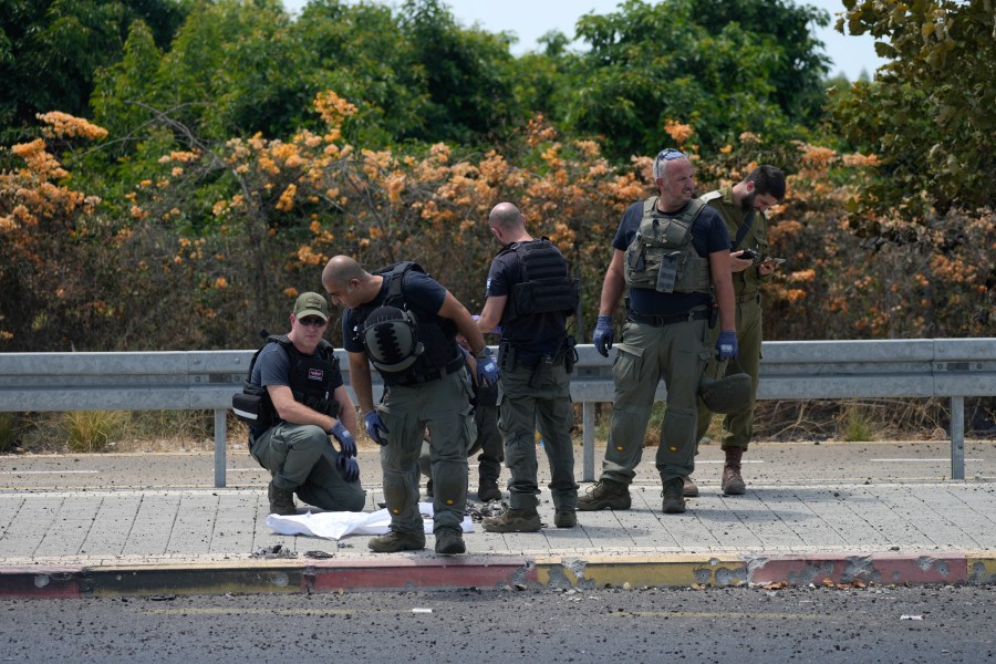 Israeli Police work at the site of a drone strike in Nahariya, Israel, Tuesday, Aug. 6, 2024. (AP Photo/Ohad Zwigenberg)