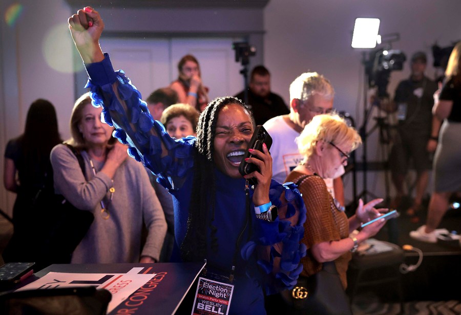 Wesley Bell supporter Shawntelle Fisher takes a call learning of the victory of Bell in the Democratic congressional primary against incumbent U.S. Rep. Cori Bush on Tuesday, Aug. 6, 2024, in St. Louis. (Robert Cohen/St. Louis Post-Dispatch via AP)