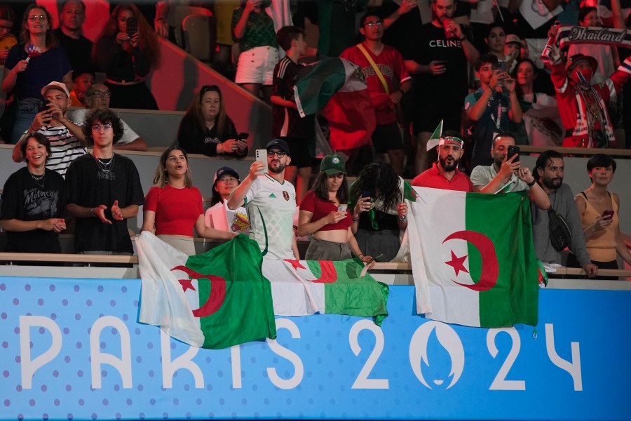 Fans of Algeria cheer ahead of Thailand's Janjaem Suwannapheng fight against Algeria's Imane Khelif in their women's 66 kg semifinal boxing match at the 2024 Summer Olympics, Tuesday, Aug. 6, 2024, in Paris, France. (AP Photo/John Locher)