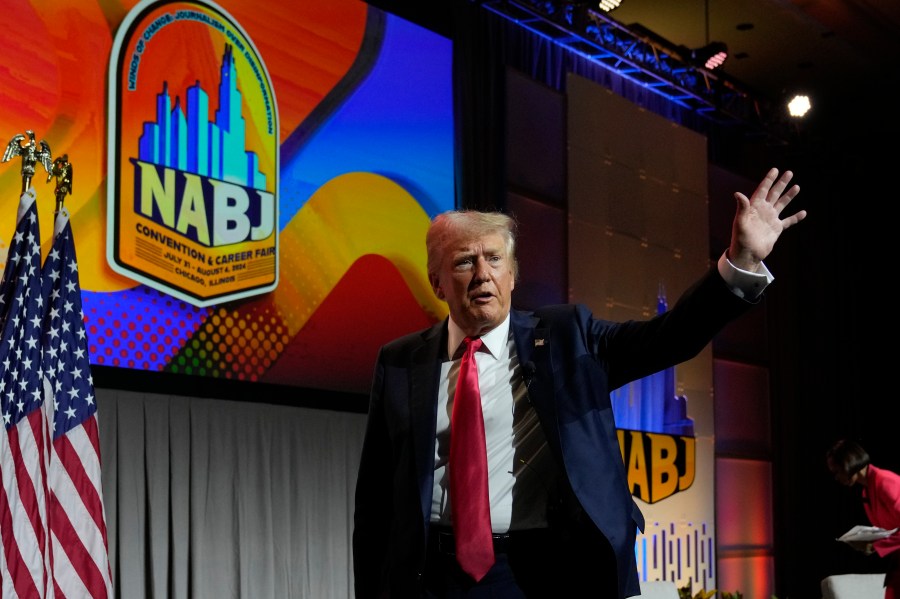 Republican presidential candidate former President Donald Trump waves as he walks off stage after speaking at the National Association of Black Journalists, NABJ, convention, Wednesday, July 31, 2024, in Chicago. (AP Photo/Charles Rex Arbogast)