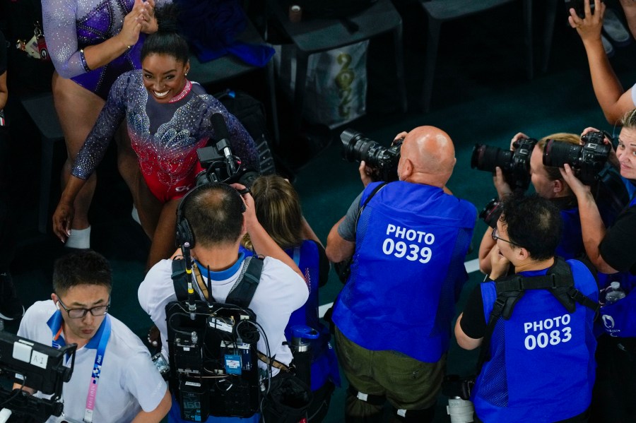 Simone Biles, of the United States, smiles after she performs on the floor during the women's artistic gymnastics individual floor finals in Bercy Arena at the 2024 Summer Olympics, Monday, Aug. 5, 2024, in Paris, France. (AP Photo/Morry Gash)