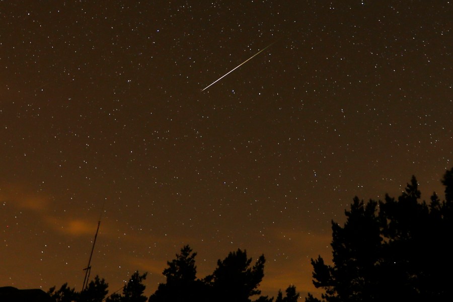 FILE - In this long exposure photo, a streak appears in the sky during the annual Perseid meteor shower at the Guadarrama mountains, near Madrid, in the early hours of Aug. 12, 2016. (AP Photo/Francisco Seco, File)