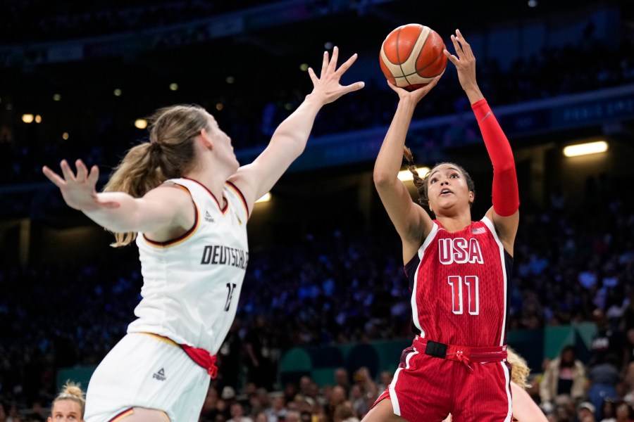 Napheesa Collier (11), of the United States, shoots over Luisa Geiselsoder (15), of Germany, in a women's basketball game at the 2024 Summer Olympics, Sunday, Aug. 4, 2024, in Villeneuve-d'Ascq, France. (AP Photo/Mark J. Terrill)