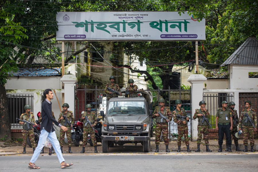 Army personnel stand guard in front of Shahbagh Police Station, near Dhaka University in Dhaka, Bangladesh, Friday, Aug. 9, 2024. (AP Photo/Rajib Dhar)