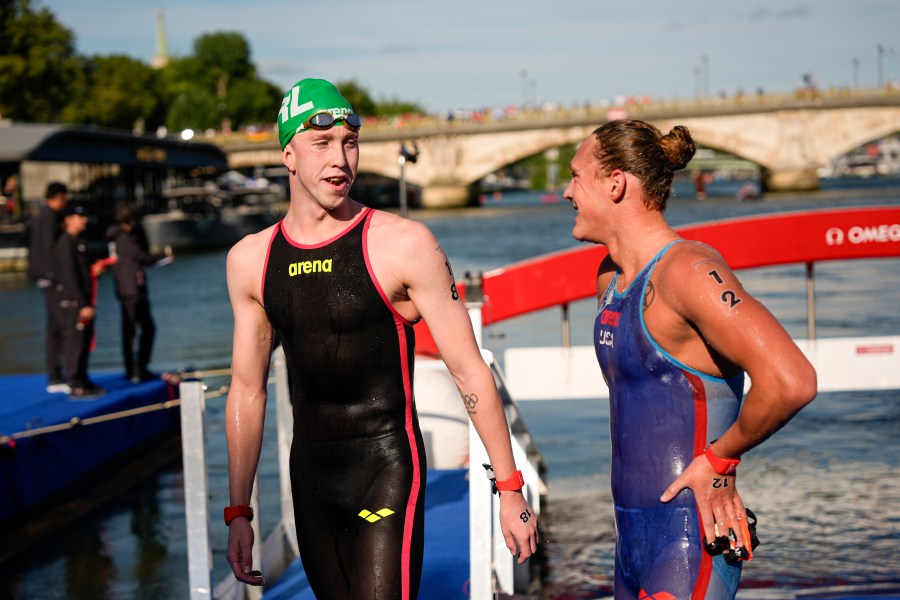 Ireland's Daniel Wiffen, left, talks to Ivan Puskovitch, of the United States, right, after crossing the finish line at the end of the marathon swimming men's 10km competition at the 2024 Summer Olympics, Friday, Aug. 9, 2024, in Paris, France. (AP Photo/David Goldman)