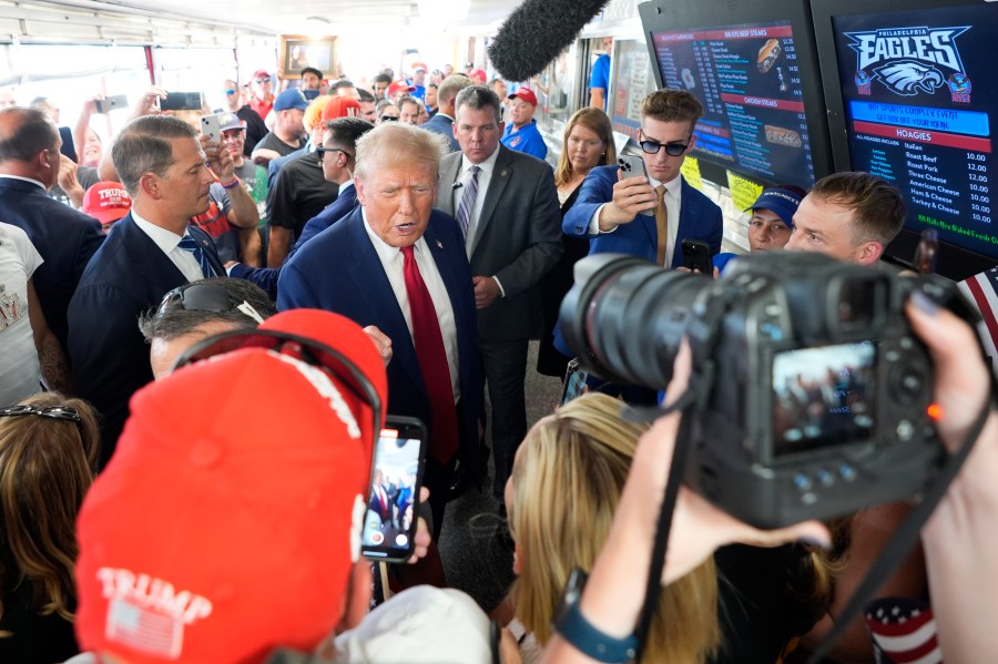 FILE - Republican presidential candidate former President Donald Trump, center, greets customers and staff at Tony and Nick's Steaks, June 22, 2024, in Philadelphia. (AP Photo/Chris Szagola, File)