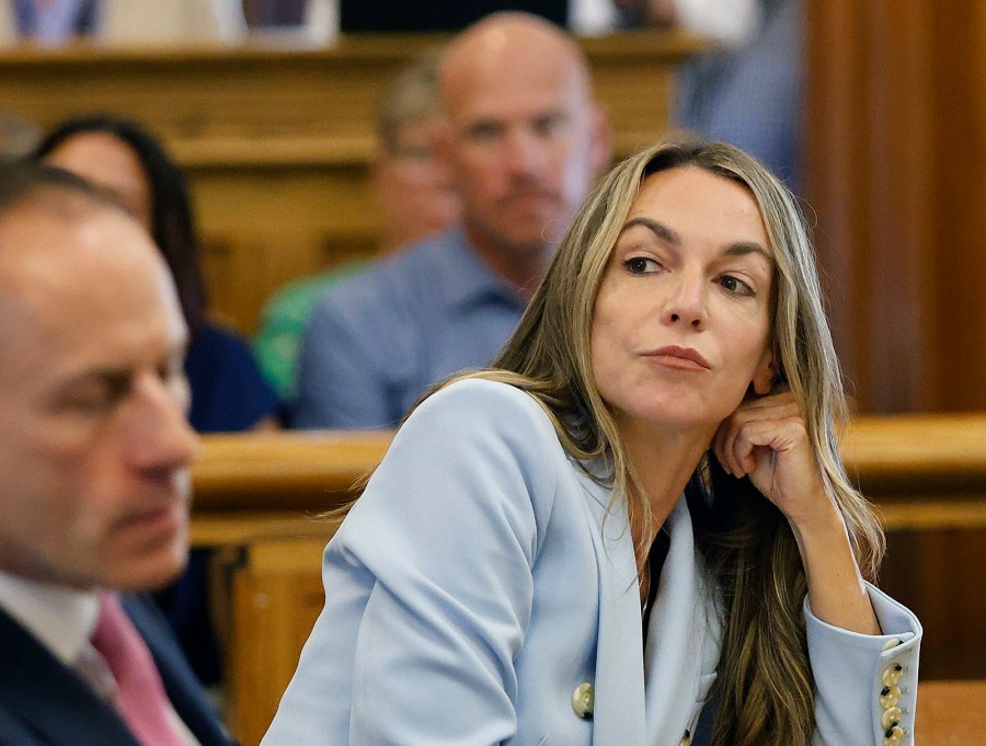 Karen Read listens to her attorney, Martin Weinberg, who was making motions to dismiss two charges against her, at Norfolk Superior Court in Dedham, Mass., Friday, Aug. 9, 2024. (Greg Derr/The Patriot Ledger via AP, Pool)