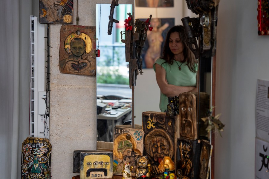 Lidiia Guzhva, a curator of the exhibition "A Snapshot in Time," looks at the art installation in Paris, France, Sunday, Aug. 4, 2024. (AP Photo/Hanna Arhirova)