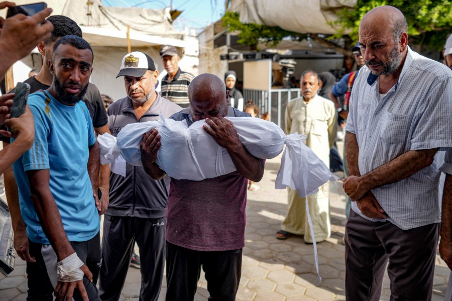 Palestinians mourn for a relative killed in the Israeli bombardment of the Gaza Strip, at a hospital in Deir al-Balah, Saturday, Aug. 10, 2024. (AP Photo/Abdel Kareem Hana)