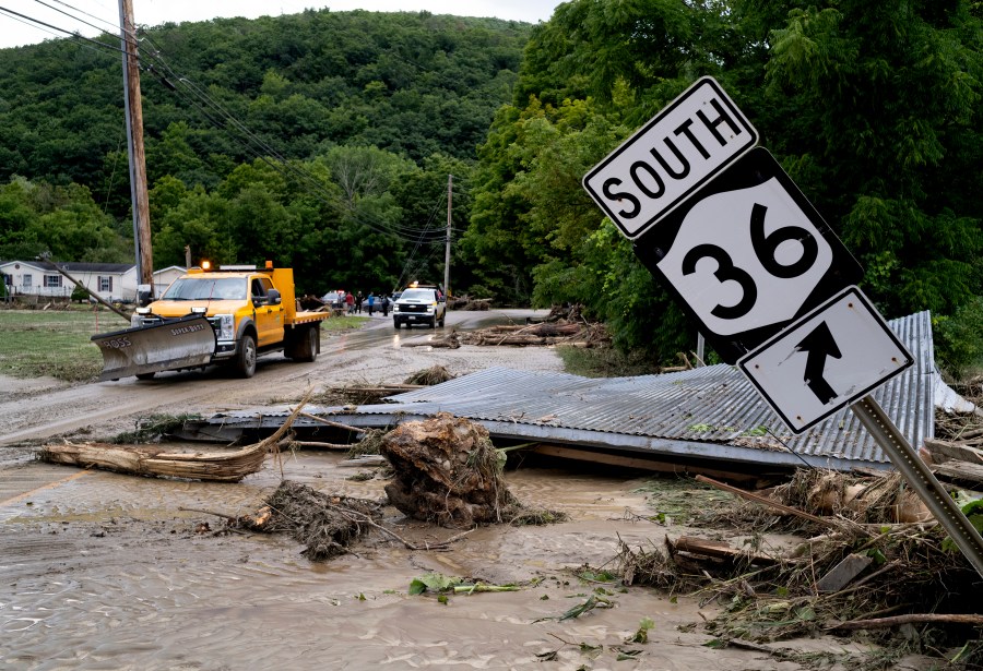 Debris from a building is seen along Route 36 in Canisteo, N.Y., Friday, Aug. 9, 2024, after remnants of Tropical Storm Debby swept through the area. (AP Photo/Craig Ruttle)